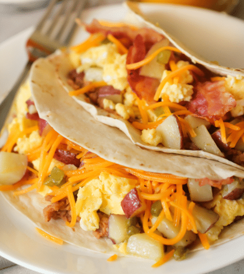 Apartments For Rent in Katy TX, Oak Park Apartments Apartments for rent in Katy TX with breakfast tacos featuring bacon and potatoes on a plate at Oak Park Apartments.