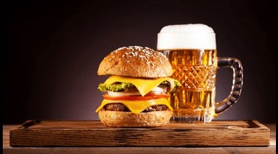 Apartments For Rent in Katy TX, Oak Park Apartments A burger and a beer on a wooden table at Oak Park Apartments.