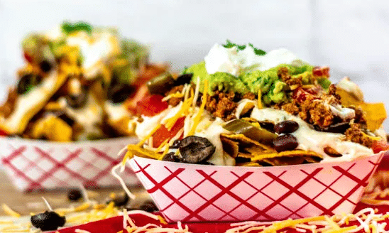 Apartments For Rent in Katy TX, Oak Park Apartments A delicious bowl of nachos topped with creamy guacamole and tangy sour cream.