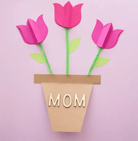 Apartments For Rent in Katy TX, Oak Park Apartments A paper flower pot with the word mom, surrounded by pink tulips.