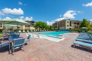 Apartments for Rent in Katy, TX - Pool with Waterfall, Tanning Shelf, Lounges & Tables with Umbrellas   