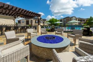 Apartments in Katy, Texas - Outdoor Fire Pit and Patio Area with View to Pool